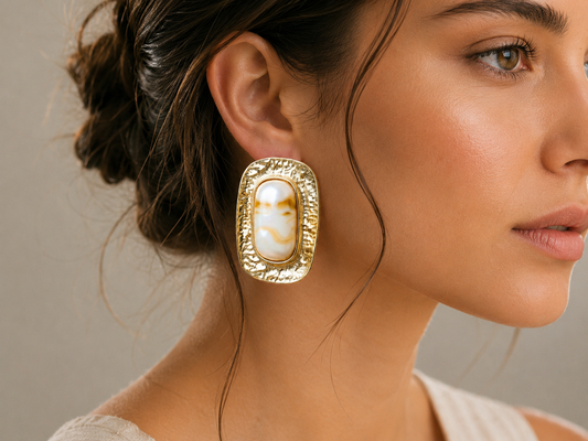 18K gold plated marbled resin oval stud earrings styled on model.
