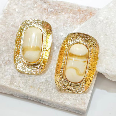 Side view of 18K gold plated marbled resin oval stud earrings showing depth and texture.